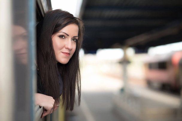 Young woman traveling by train - Valokuva, kuva