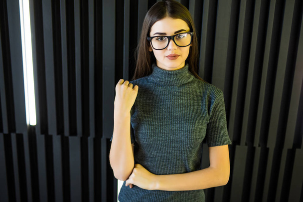Portrait beautiful happy young woman with glasses smiling on modern office background wall. - Fotoğraf, Görsel