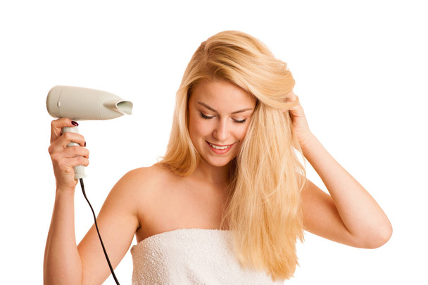 Blonde woman drieing her hair with air blower isolated over whit - Foto, imagen