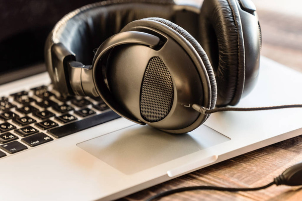 Modern headphones on the laptop - Photo, Image