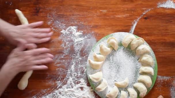 Elderly woman make dough for russian dumpling, top view, hd video - Footage, Video