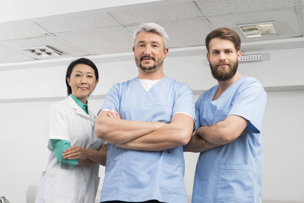 Portrait Of Confident Doctors Standing Arms Crossed - Photo, Image
