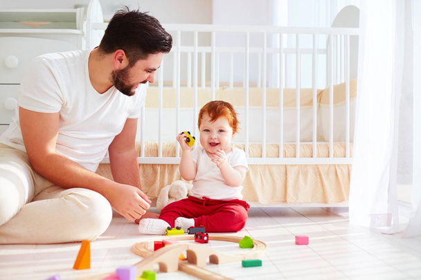 happy father playing with infant baby boy at sunny nursery room - Zdjęcie, obraz