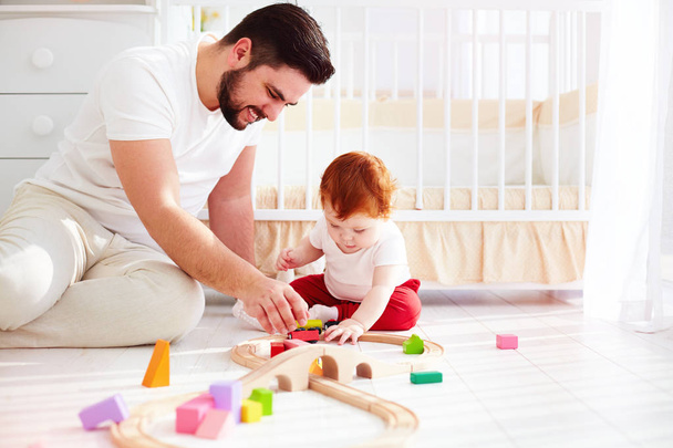 happy father playing with infant baby boy at sunny nursery room - Foto, Imagem