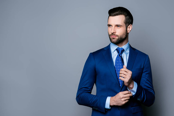 Portrait of serious fashionable handsome man in blue suit and ti - Photo, Image