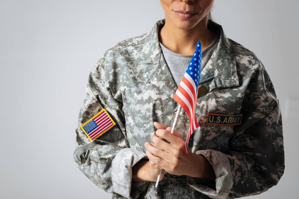 woman wearing  uniform and holding  flag - Foto, Imagen