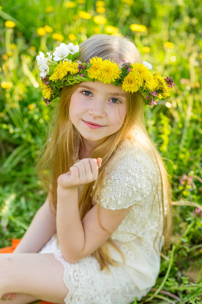 A beautiful little girl runs through a flowering garden in the s - Photo, Image