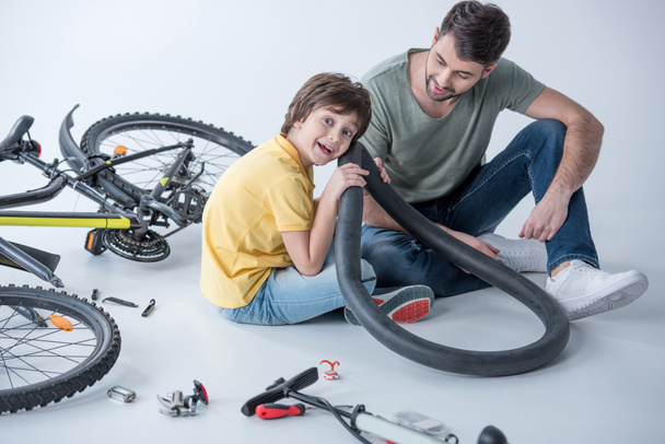 father and son repairing bicycle  - Photo, Image