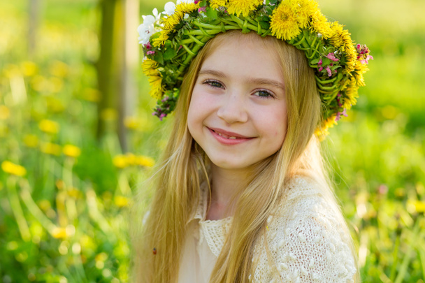 A beautiful little girl runs through a flowering garden in the s - Φωτογραφία, εικόνα