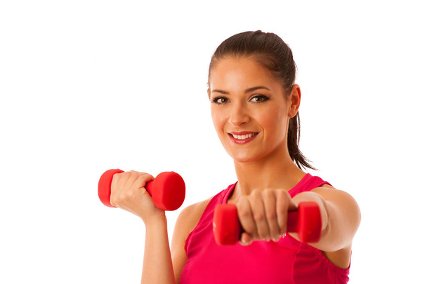 Active young woman workout with dumbbells in fitness gym isolate - Φωτογραφία, εικόνα