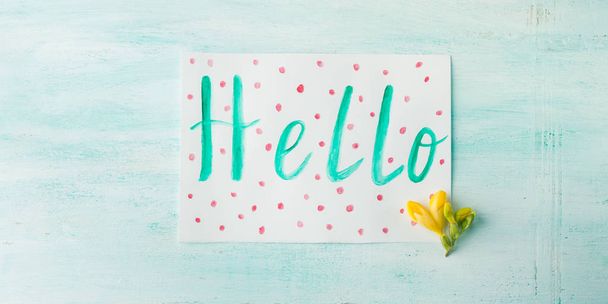 Hello word spelling by watercolor hand lettering yellow flowers - Foto, imagen