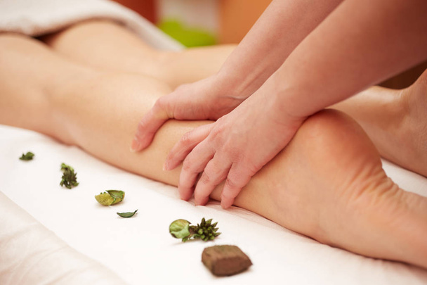 Detail of hands massaging human calf muscle.Therapist applying pressure on female leg - Φωτογραφία, εικόνα