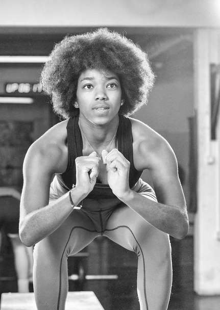 black female athlete is performing box jumps at gym - 写真・画像