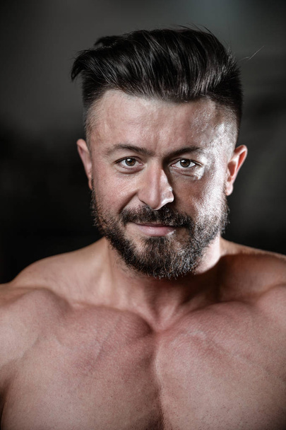 Brutal strong bodybuilder man pumping up muscles and train gym - Φωτογραφία, εικόνα