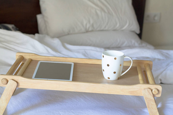digital tablet technology and coffee in bed - 写真・画像