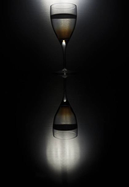 Drop of ink in glass of water silhouette - Foto, imagen