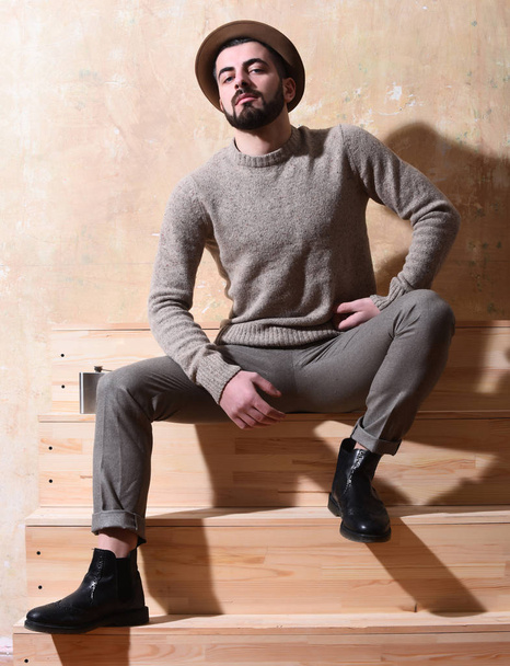 bearded man sitting on stairs with serious face - Fotografie, Obrázek