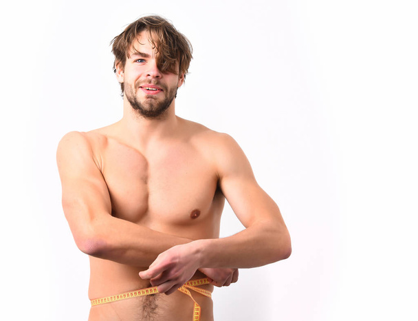 Caucasian sexy young macho uses measuring tape - 写真・画像