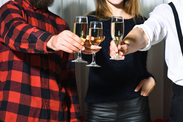 Female and male hands clinking glasses with wine - Foto, afbeelding