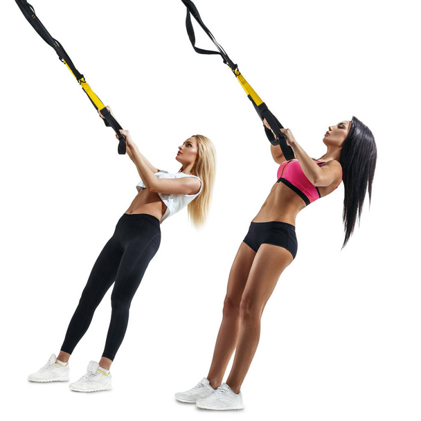 Fitness women do thrust with trx suspension - Valokuva, kuva