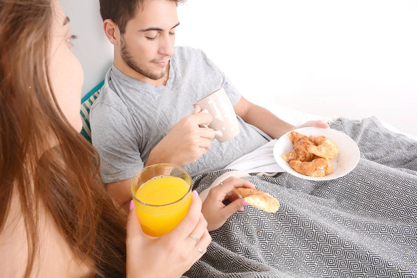 Couple having breakfast in bed. - Fotó, kép