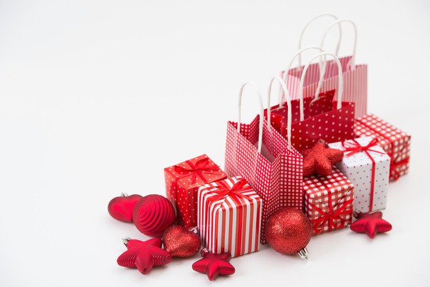 Gift boxes with xmas presents wrapped in red paper with ornament - Fotó, kép