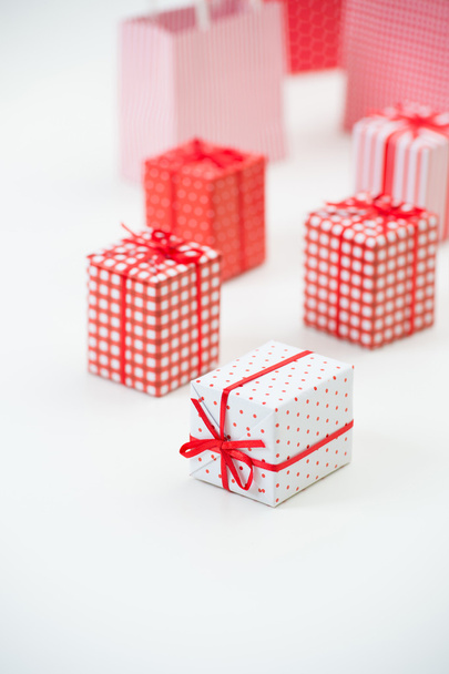 Gift boxes with xmas presents wrapped in red paper with ornament - Fotografie, Obrázek