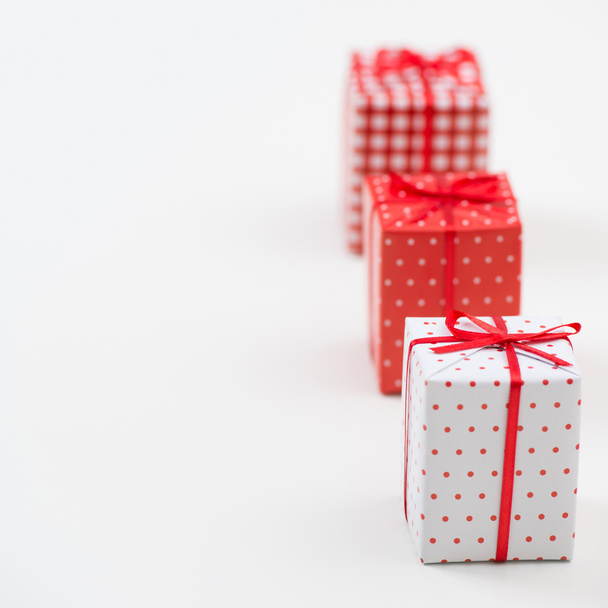 Gift boxes with xmas presents wrapped in red paper with ornament - Valokuva, kuva