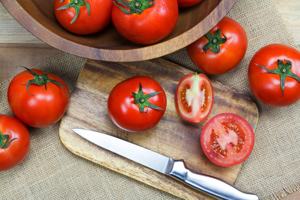 Closeup Fresh ripe tomatoes on wood background - Photo, image
