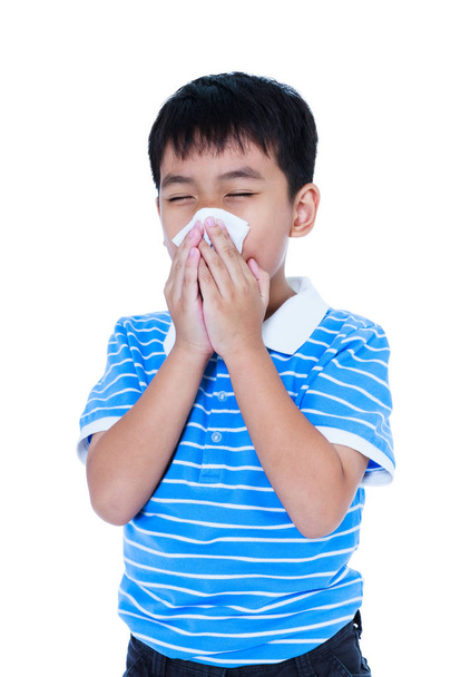 Handsome asian boy blowing his nose into tissueon. Isolated on w - Photo, Image