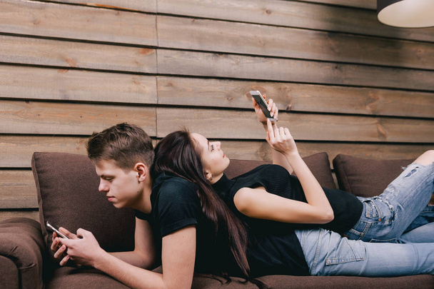 young couple lying in bed with digital phone - Foto, imagen