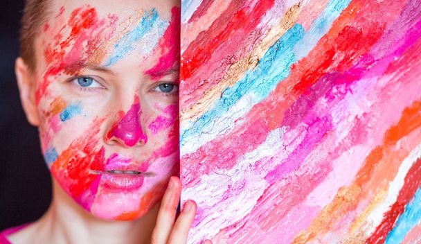 Portrait of beautiful woman with colorful makeup on face - Fotoğraf, Görsel