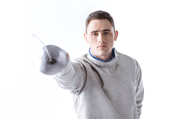 Young man fencing  - Фото, изображение