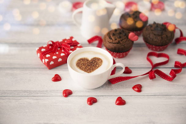 Valentine day love beautiful. Morning coffee, hearts and muffins on wooden background - Photo, Image