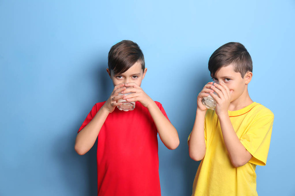 Twin brothers with milk on blue background - Foto, Imagem