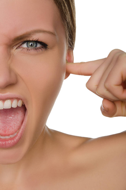 Screaming beautiful woman covers ear with her finger - Fotó, kép
