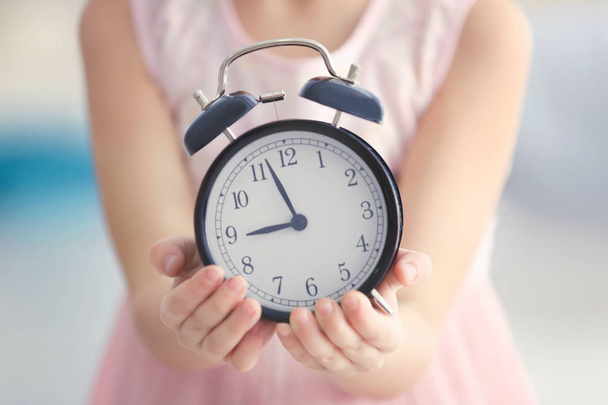 little girl with alarm clock - 写真・画像