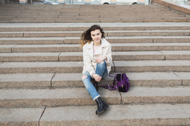 Sad girl sitting on the steps of the theater - 写真・画像
