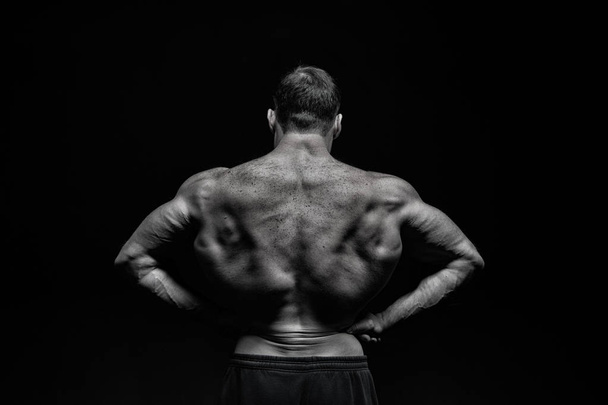 handsome bodybuilder man with muscular body training in gym - 写真・画像