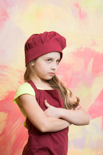 small girl chef with serious face in hat and apron - Foto, imagen