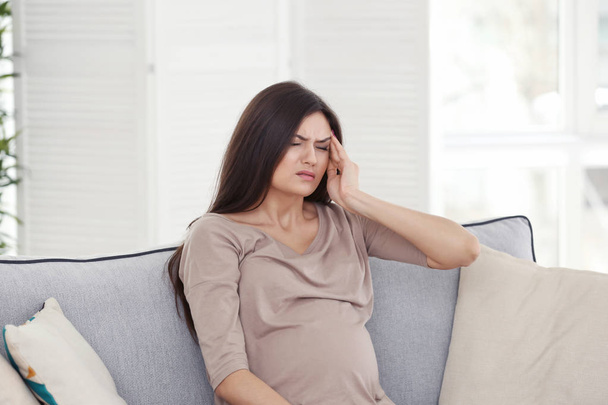 Young pregnant woman suffering from headache at home - Φωτογραφία, εικόνα
