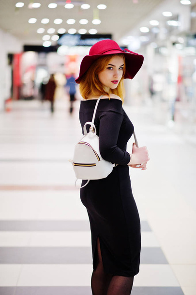 Fashion red haired girl wear on black dress and red hat with lad - Photo, Image