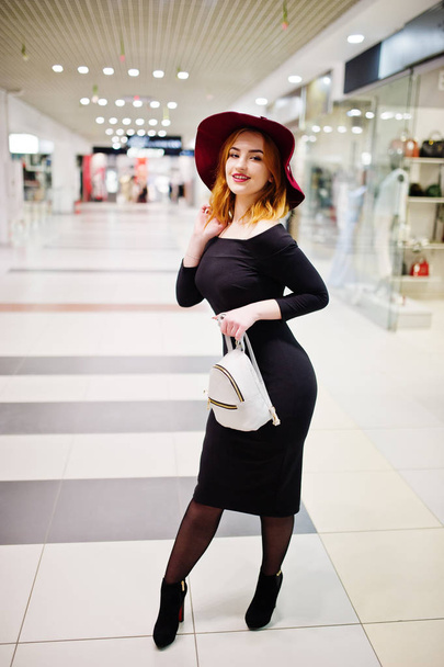 Fashion red haired girl wear on black dress and red hat with lad - Фото, зображення