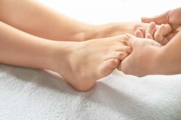 Young woman receiving foot massage in spa salon - Fotoğraf, Görsel