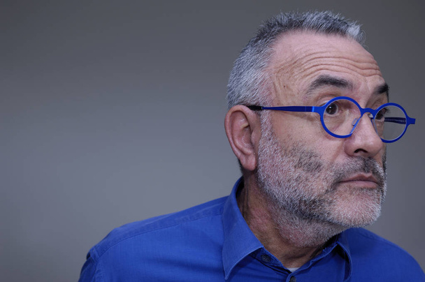 man in glasses and blue shirt staring, - Photo, Image
