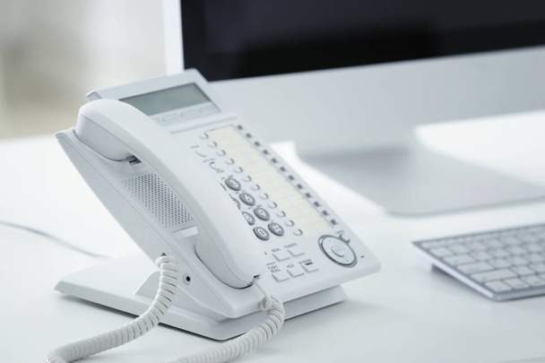 Telephone at workplace in office - Φωτογραφία, εικόνα