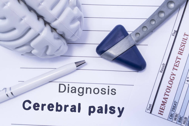 Diagnosis Cerebral palsy. Figure brain, neurological hammer, printed on a paper blood test and written diagnosis of Cerebral palsy in  medical form is lying on table in the doctor neurologist cabinet - Photo, Image