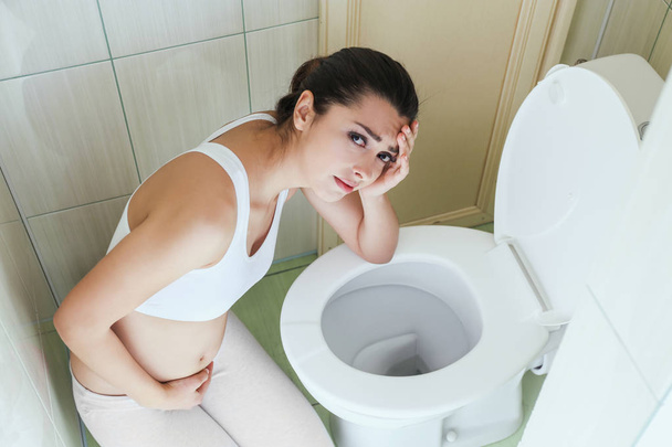 Young vomiting woman near toilet bowl at home - Φωτογραφία, εικόνα