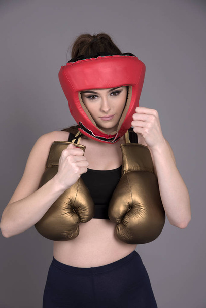 Woman boxer in a red head guard - Photo, Image
