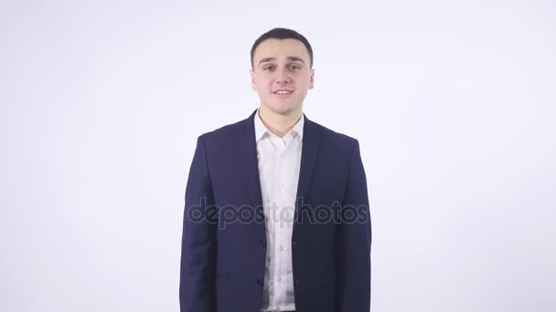 Flirting to you. Close up portrait of winking young man looking at camera isolated on white - Кадри, відео